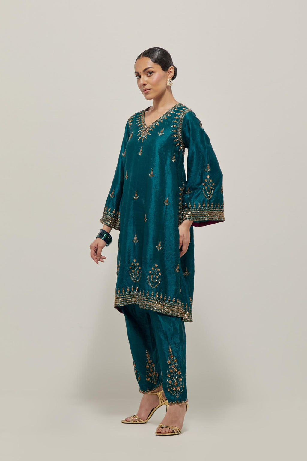 Teal Green double toned silk easy fit short kurta set with hand embroidered zardozi and sequins, highlighted with beads.