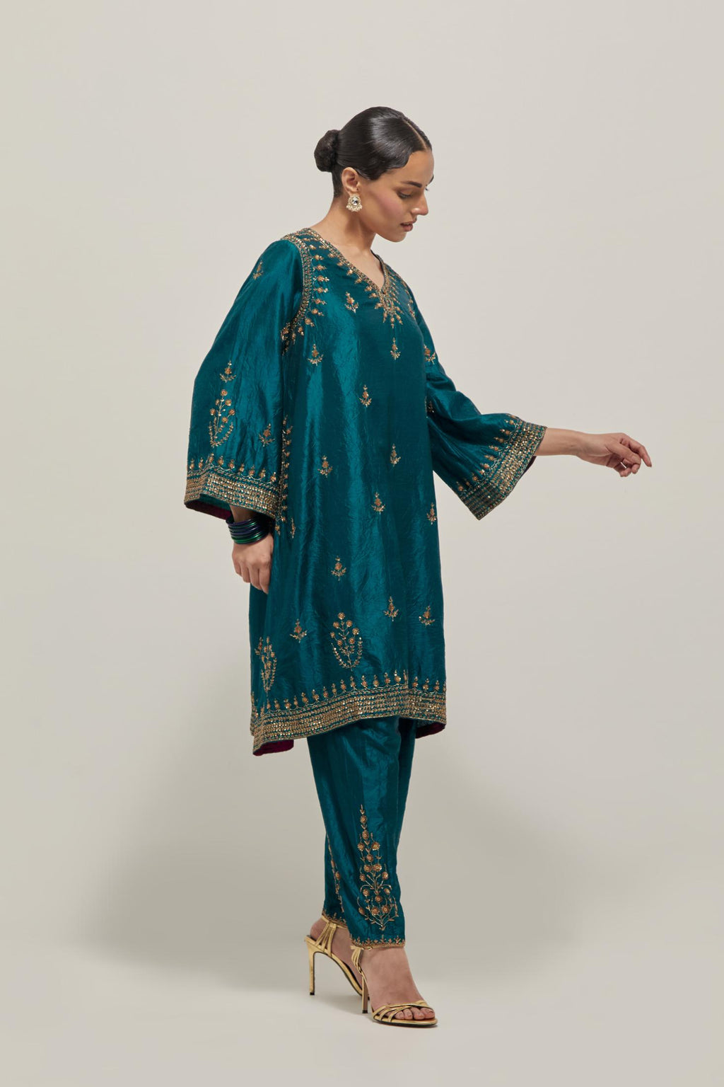 Teal Green double toned silk easy fit short kurta set with hand embroidered zardozi and sequins, highlighted with beads.