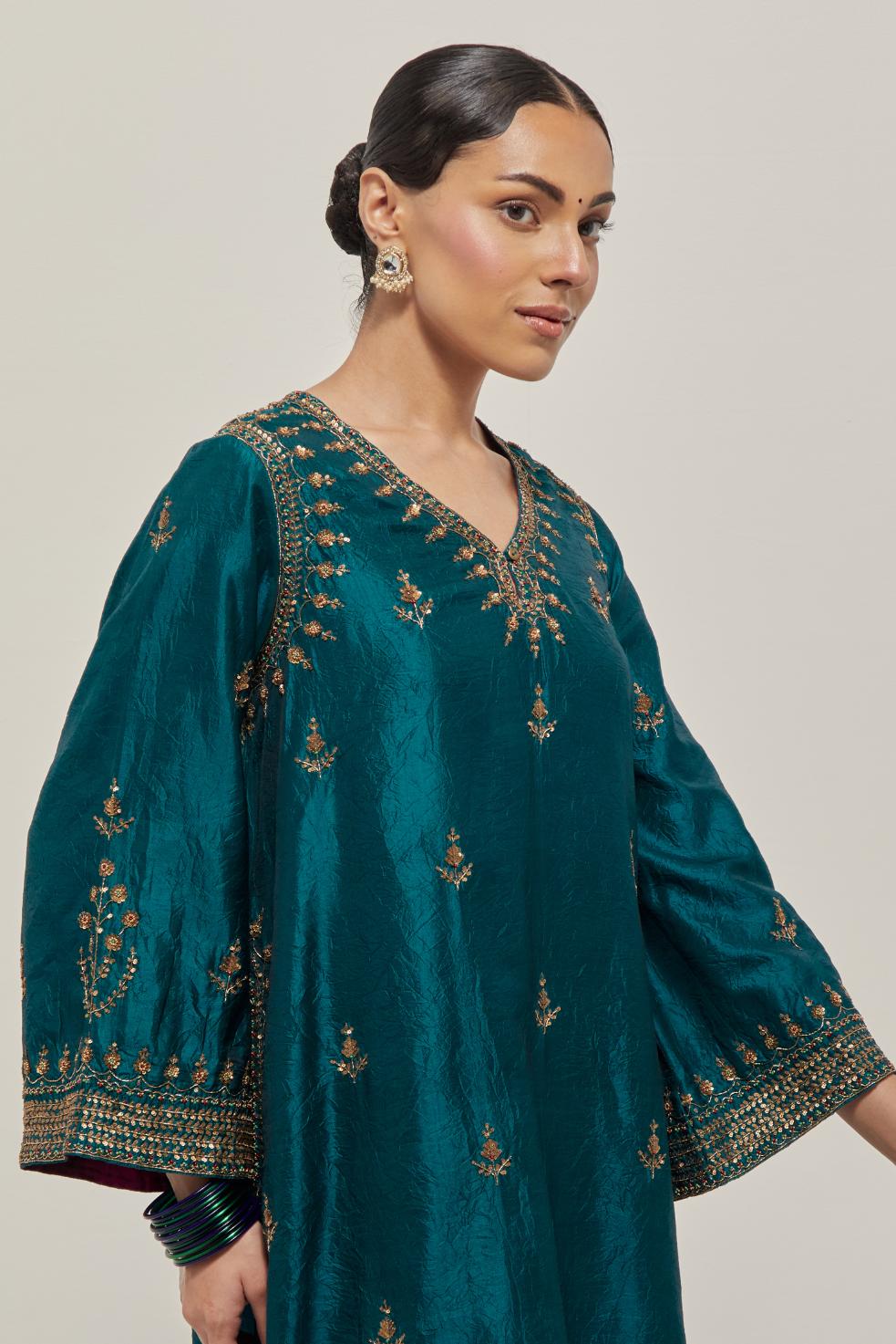 Teal Green double toned silk easy fit short kurta set with hand embroidered zardozi and sequins, highlighted with beads.