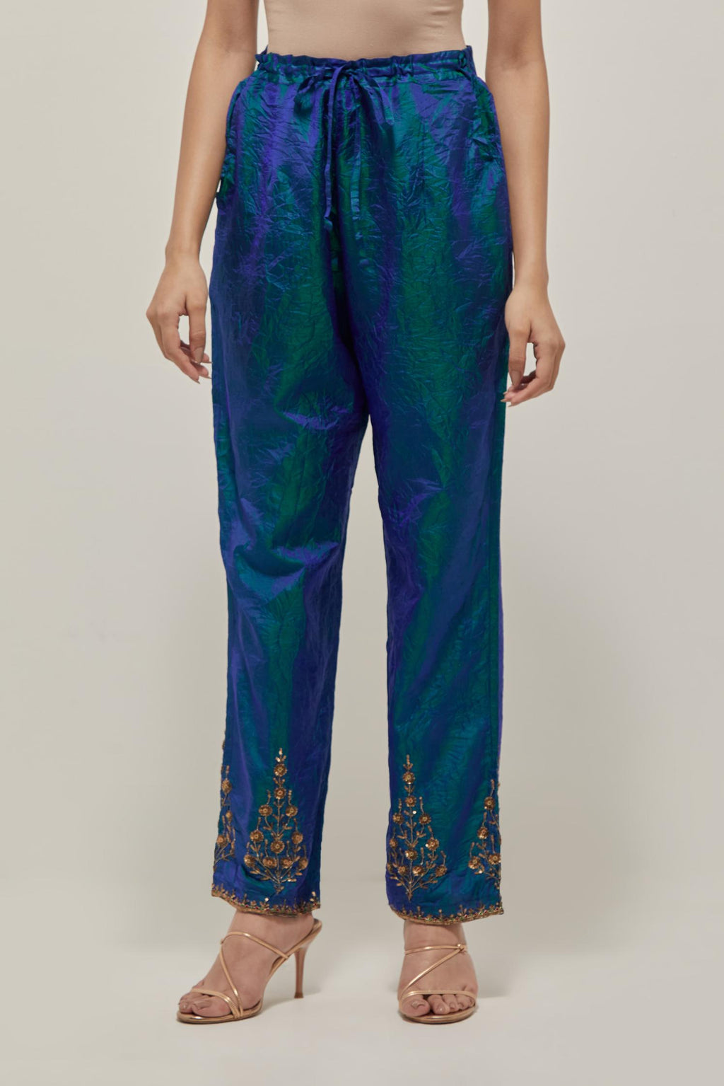 Teal Blue Silk pants, highlighted with hand embroidered bead, sequins and zardozi boota at hem, highlighted with contrast bead work.