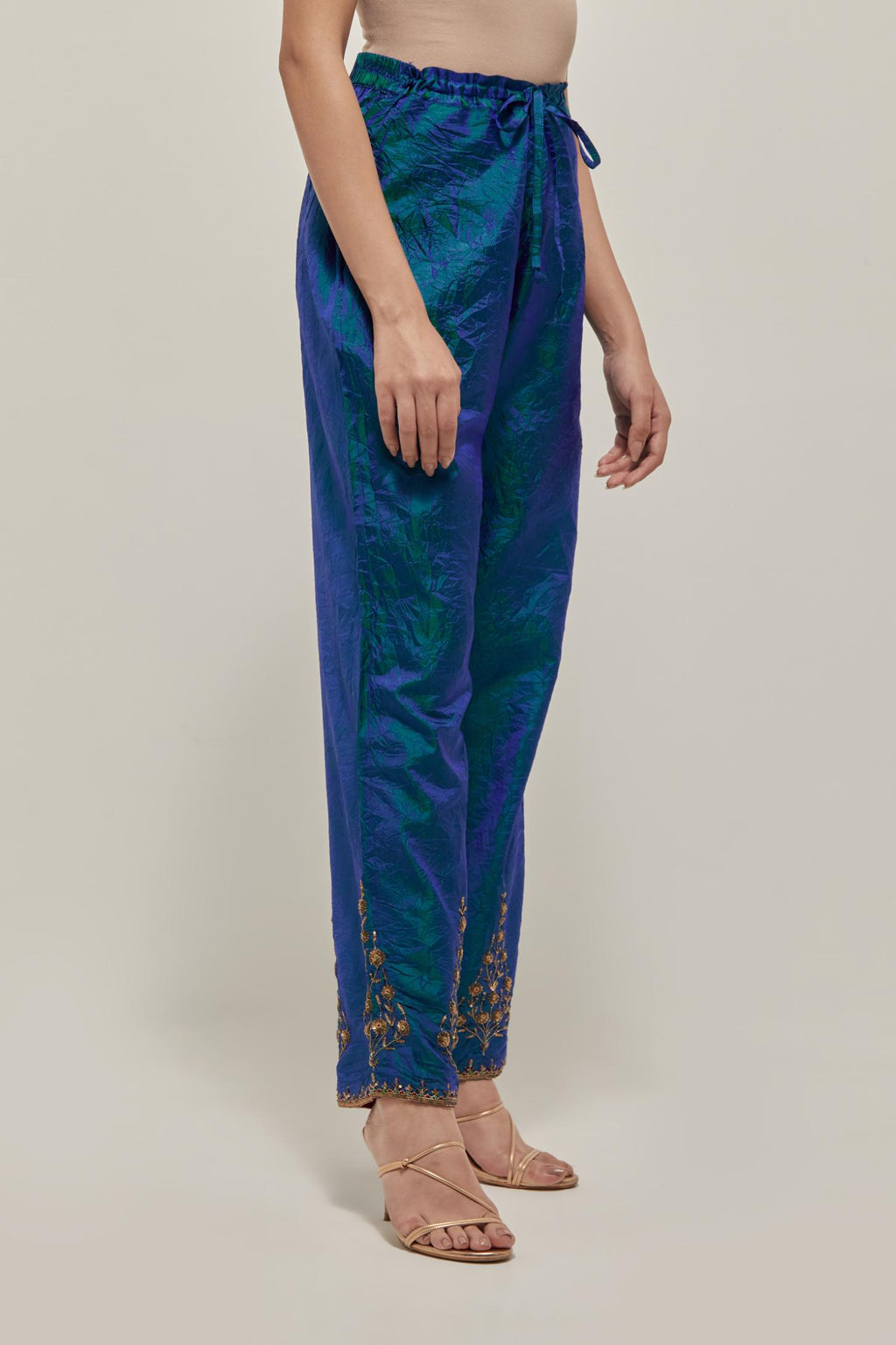 Teal Blue Silk pants, highlighted with hand embroidered bead, sequins and zardozi boota at hem, highlighted with contrast bead work.