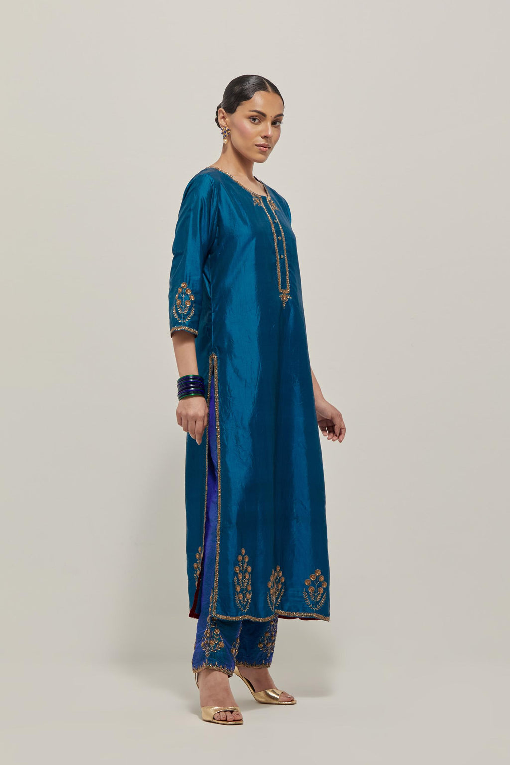 Teal double toned silk straight Kurta set with hand embroidered zardozi and sequins, highlighted with beads.