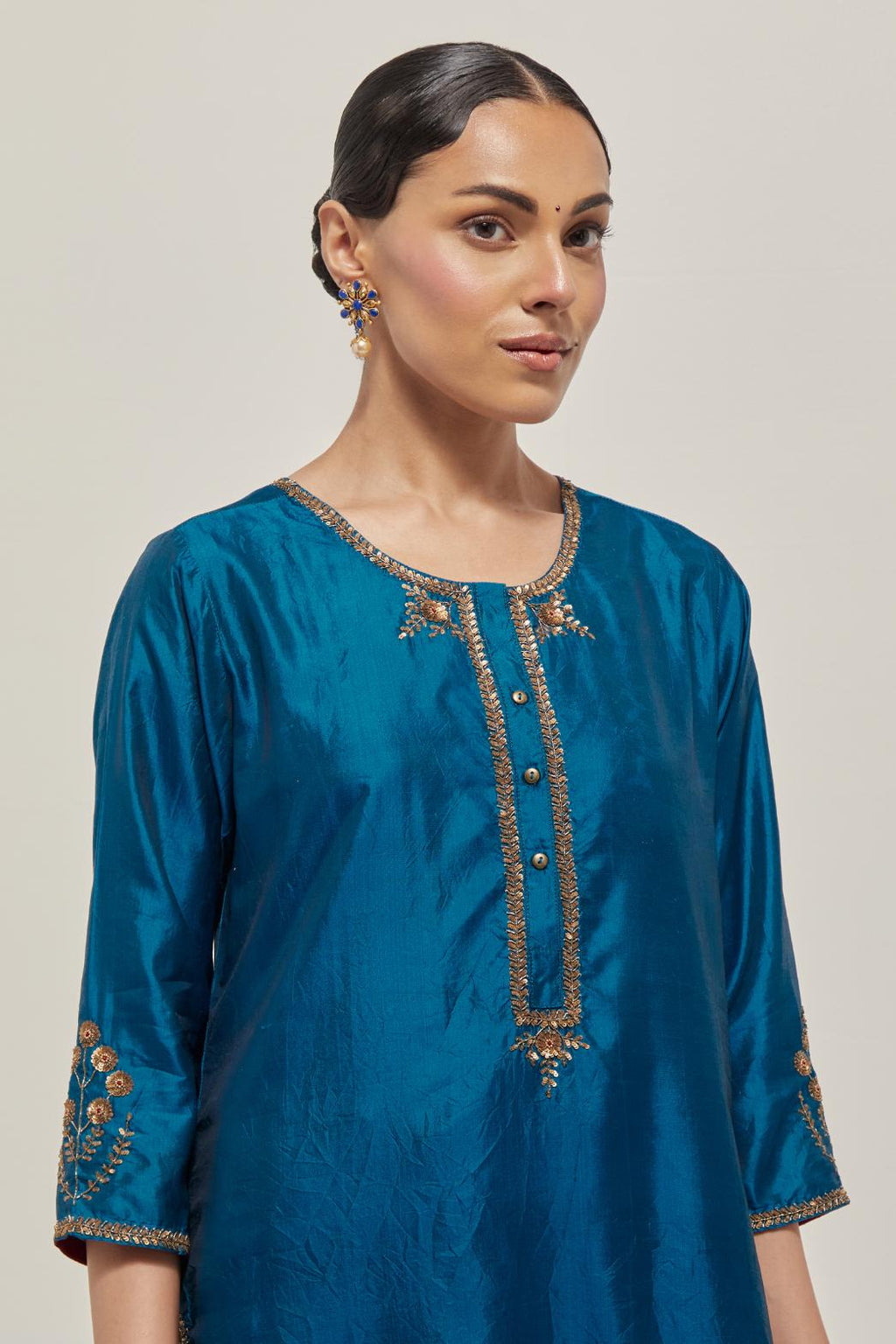 Teal double toned silk straight Kurta set with hand embroidered zardozi and sequins, highlighted with beads.