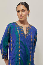 Teal Blue silk straight kurta set with round neck and slit in front. It has hand embroidered zardozi and sequins chhari stripes, all-over and heavier butas at hem, highlighted with beads.