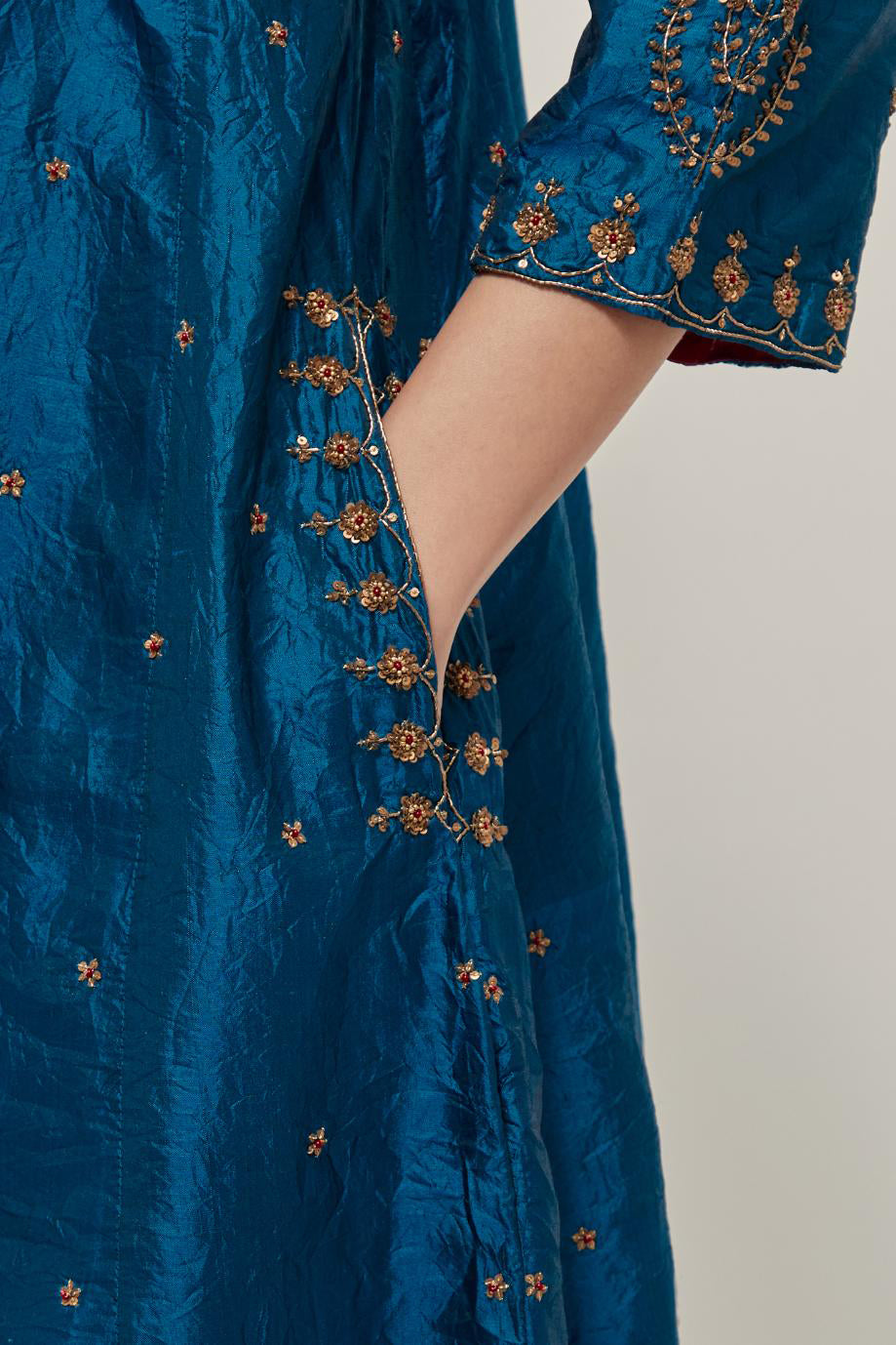 Teal double toned silk short kalidar kurta set, with hand embroidered zardozi and sequins, highlighted with beads.