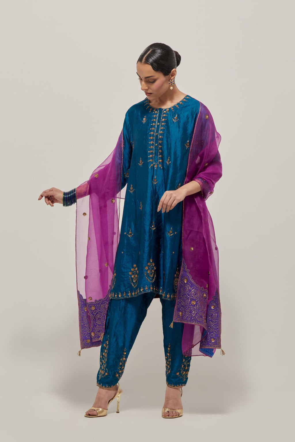 Teal double toned silk short kalidar kurta set, with hand embroidered zardozi and sequins, highlighted with beads.