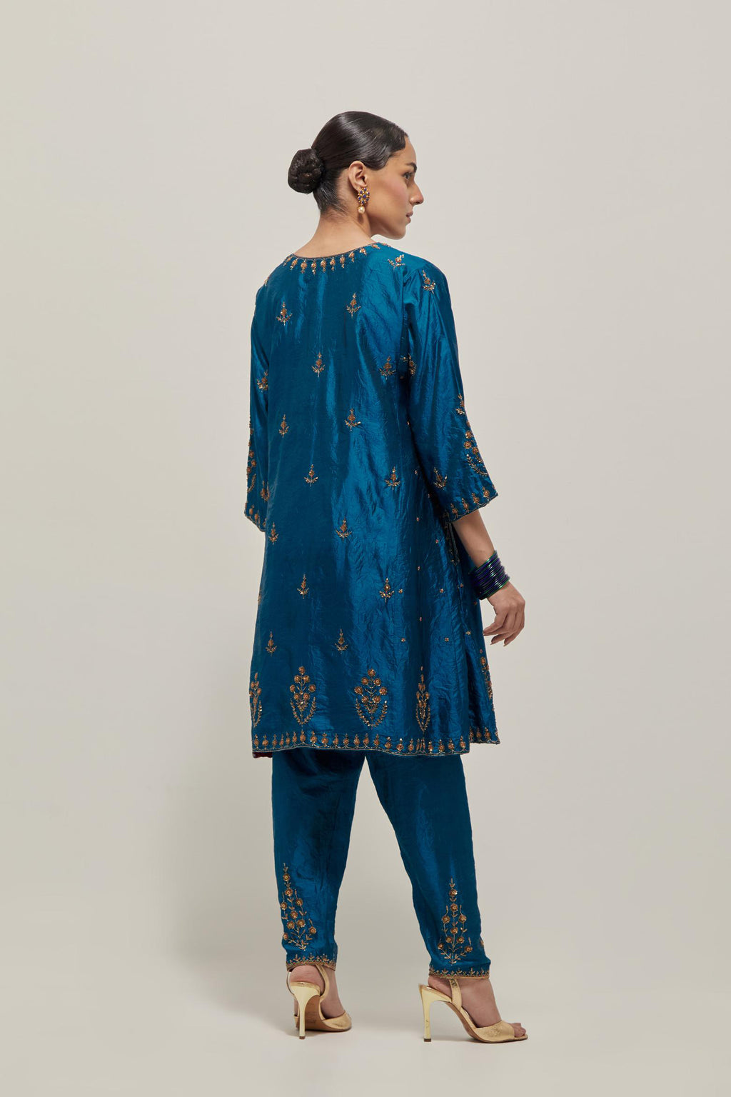 Teal double toned silk short kalidar kurta set, with hand embroidered zardozi and sequins, highlighted with beads.