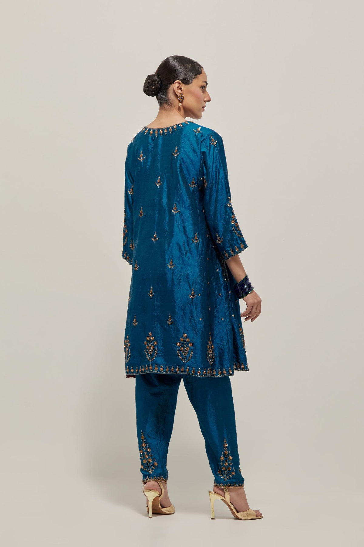 Teal double toned silk short kalidar kurta set, with hand embroidered zardozi and sequins, highlighted with beads.