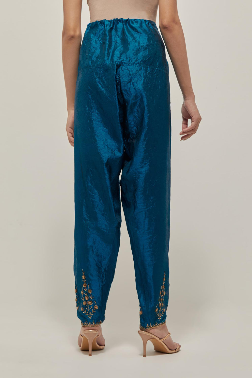 Teal Silk salwar, highlighted with hand embroidered bead, sequins and zardozi boota at hem, highlighted with contrast bead work.