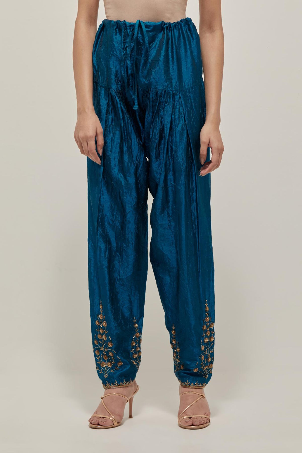 Teal Silk salwar, highlighted with hand embroidered bead, sequins and zardozi boota at hem, highlighted with contrast bead work.