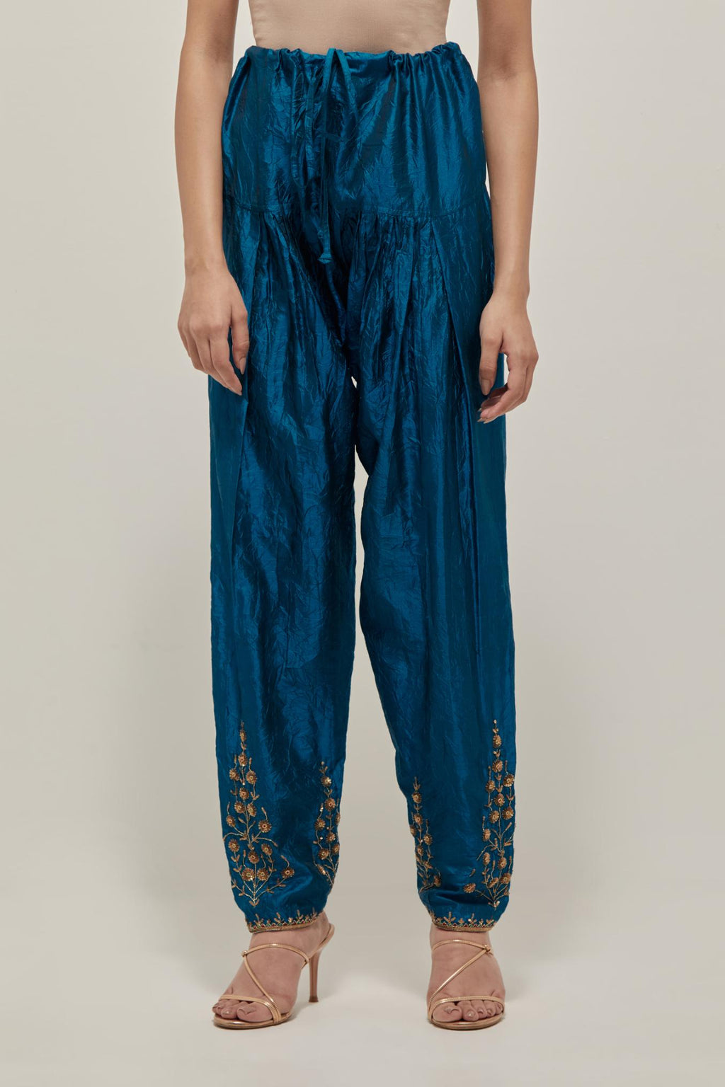 Teal Silk salwar, highlighted with hand embroidered bead, sequins and zardozi boota at hem, highlighted with contrast bead work.