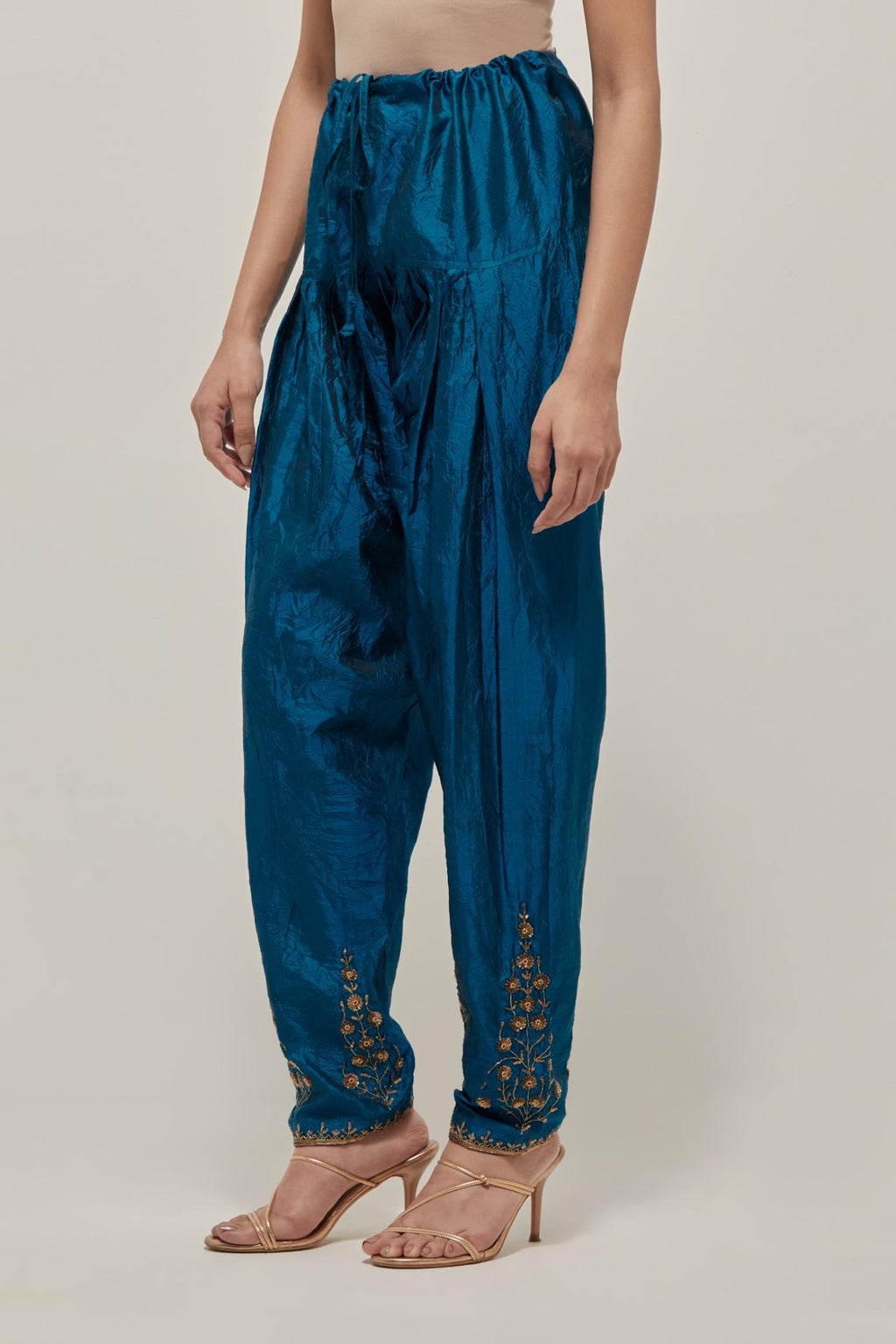 Teal Silk salwar, highlighted with hand embroidered bead, sequins and zardozi boota at hem, highlighted with contrast bead work.