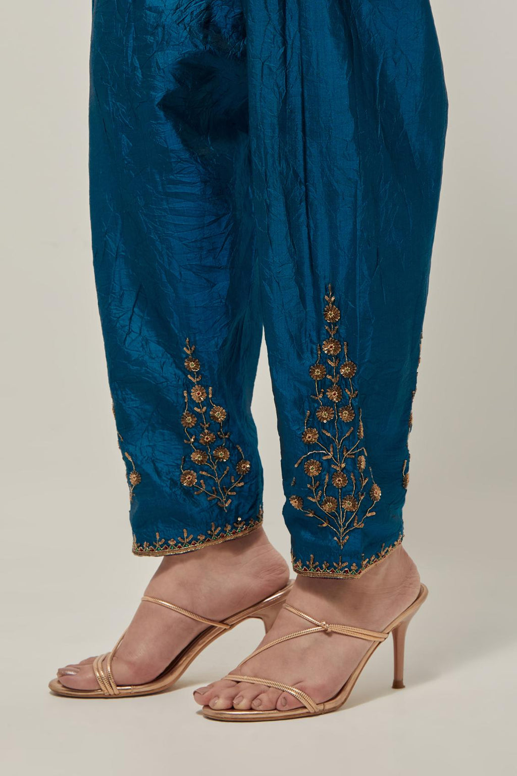 Teal Silk salwar, highlighted with hand embroidered bead, sequins and zardozi boota at hem, highlighted with contrast bead work.