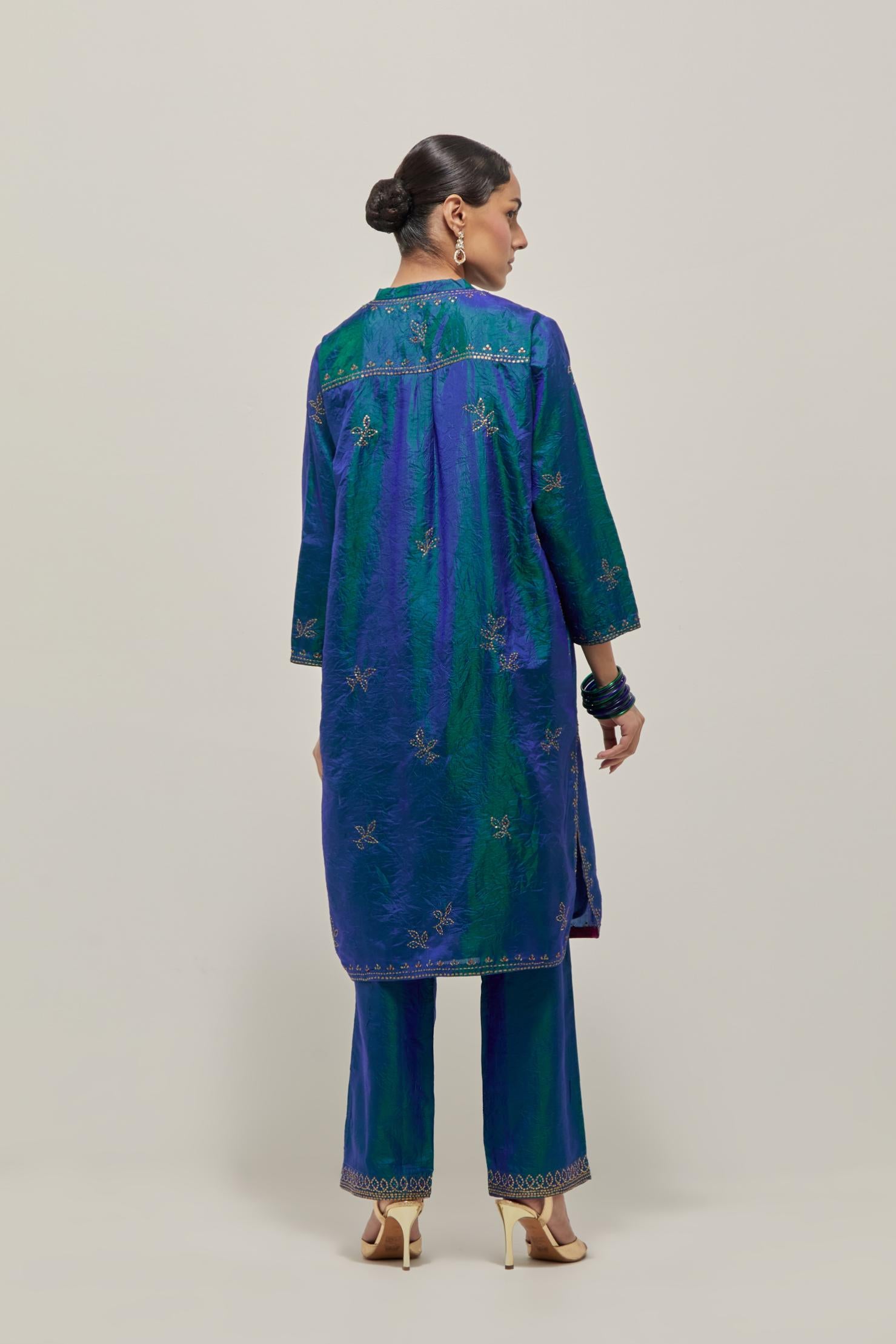 Teal Blue Silk short kurta set with hand embroidered sequins on bandhani inspired floral motifs all-over the kurta, highlighted with contrast-colored beads.