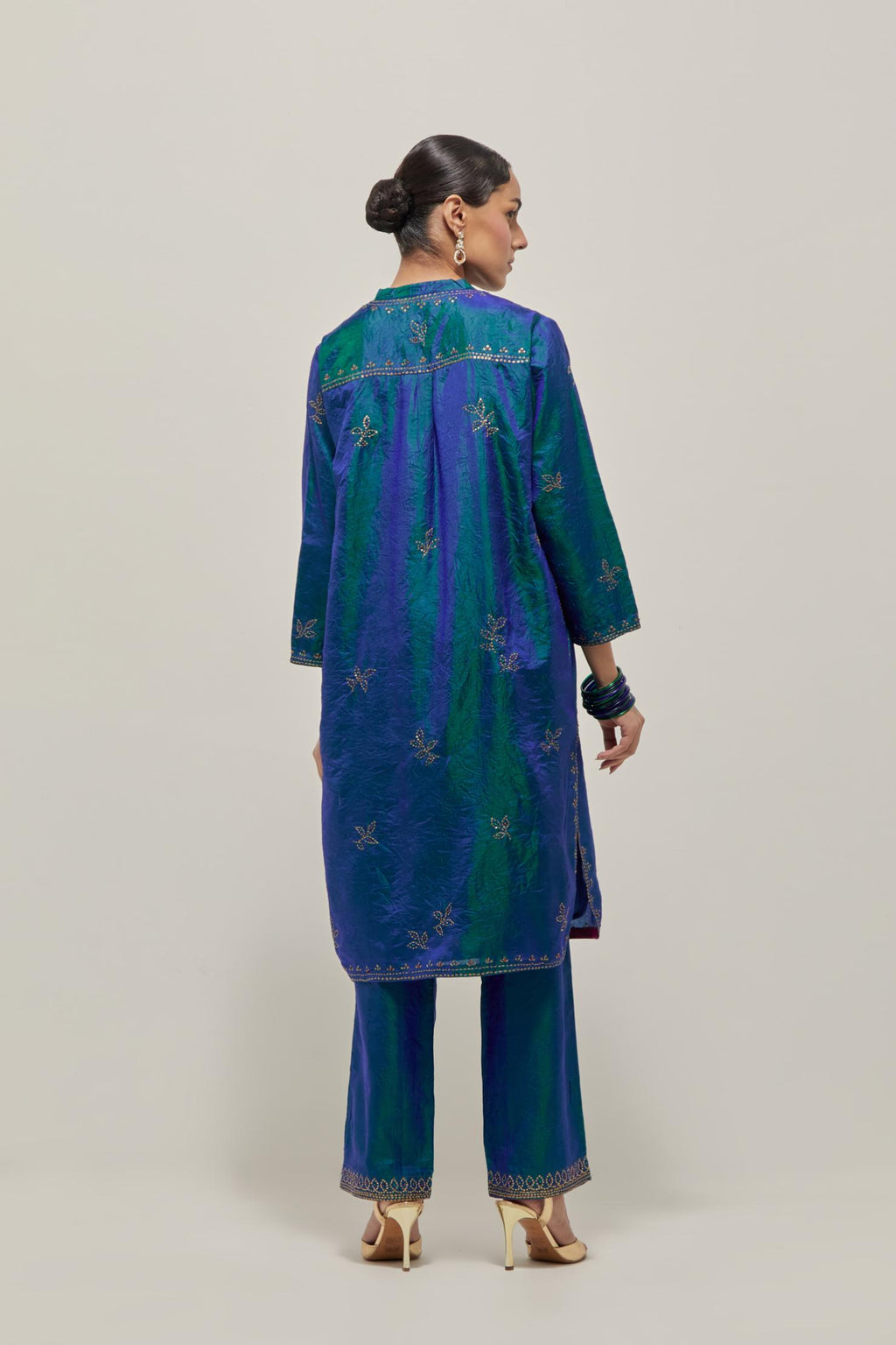 Teal Blue Silk short kurta set with hand embroidered sequins on bandhani inspired floral motifs all-over the kurta, highlighted with contrast-colored beads.