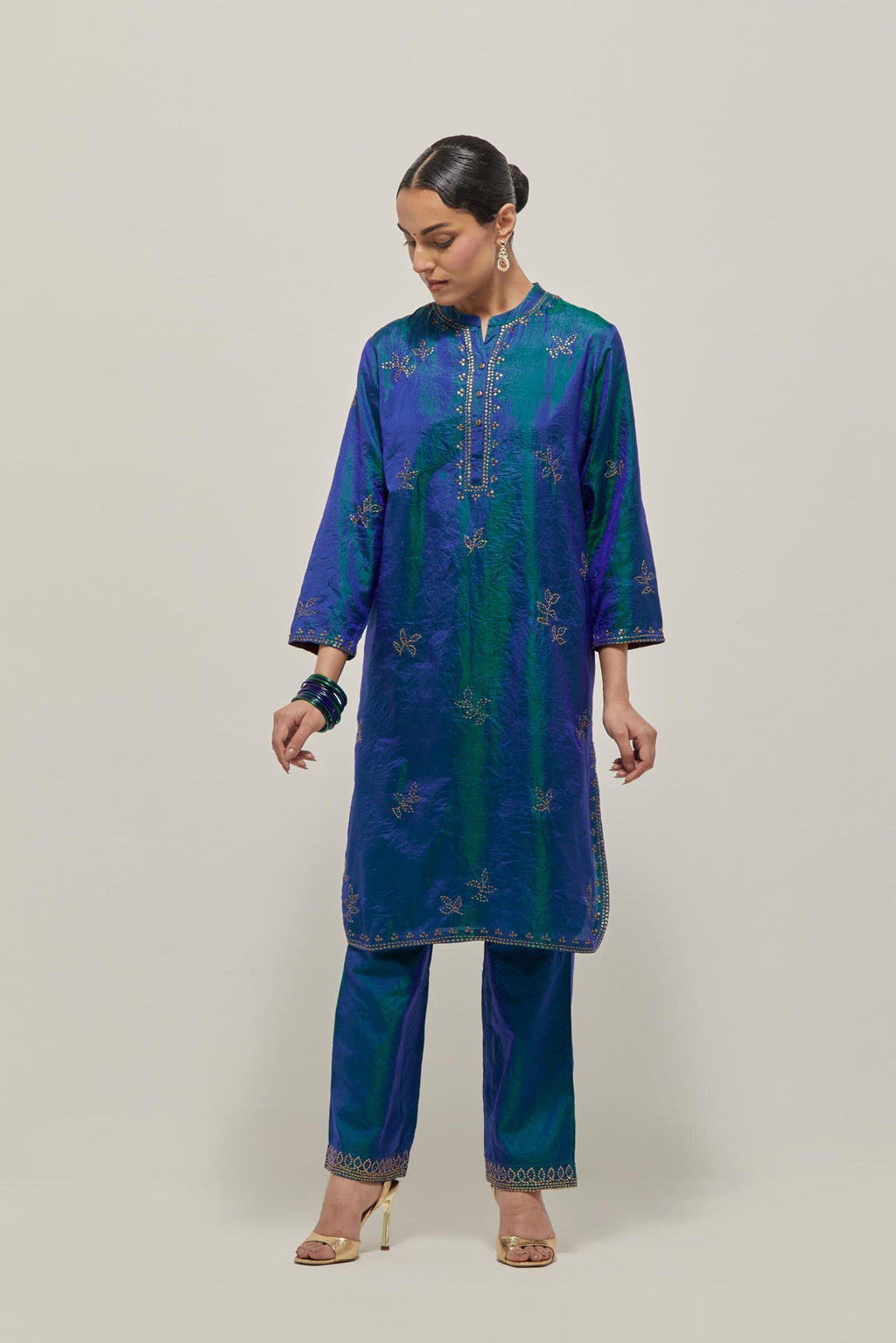 Teal Blue Silk short kurta set with hand embroidered sequins on bandhani inspired floral motifs all-over the kurta, highlighted with contrast-colored beads.