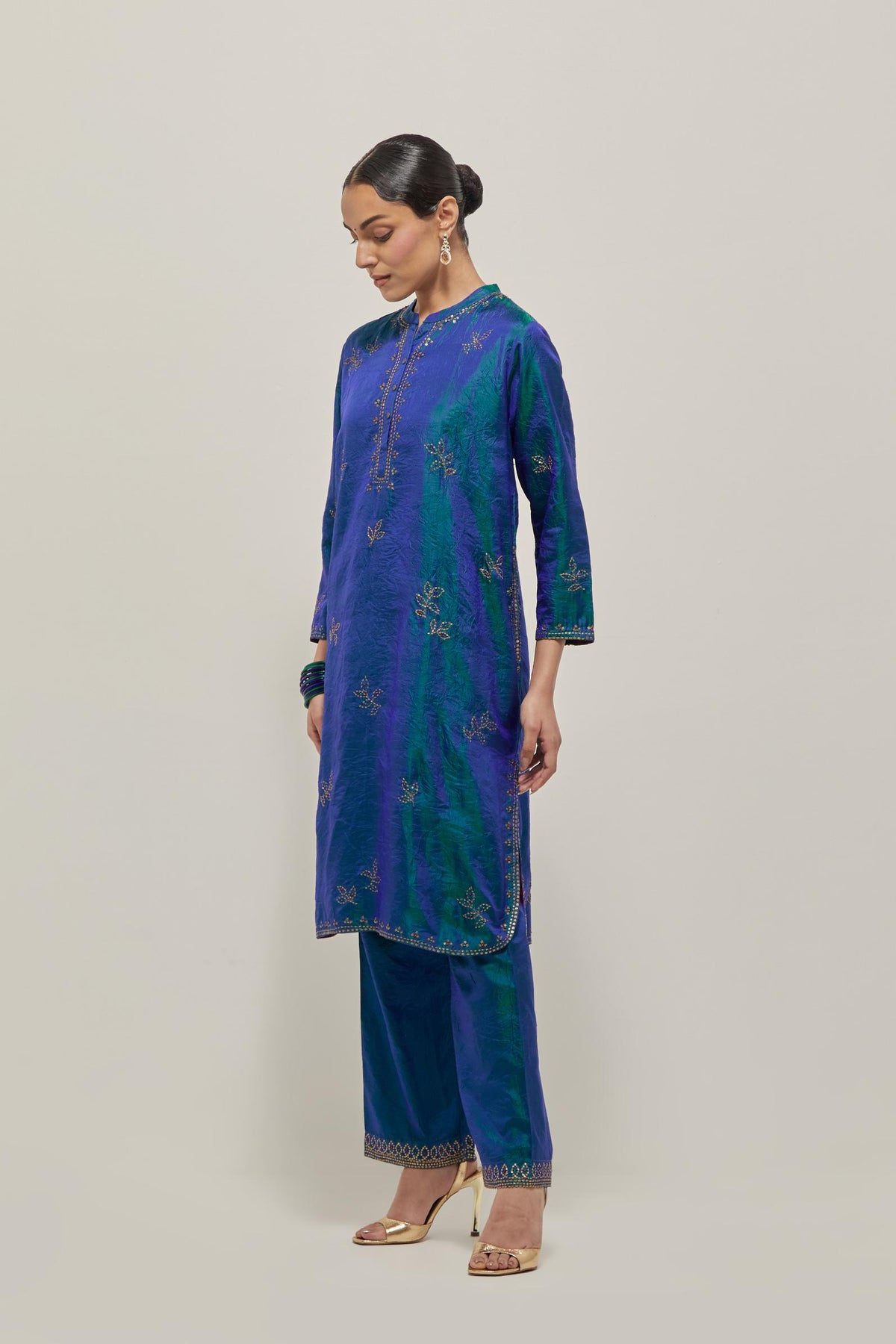 Teal Blue Silk short kurta set with hand embroidered sequins on bandhani inspired floral motifs all-over the kurta, highlighted with contrast-colored beads.