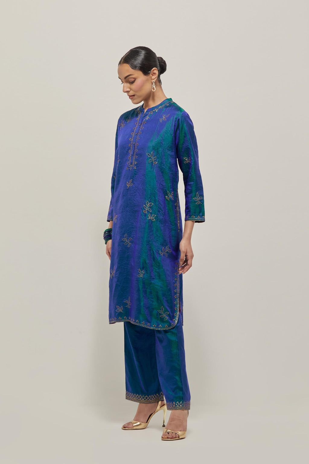 Teal Blue Silk short kurta set with hand embroidered sequins on bandhani inspired floral motifs all-over the kurta, highlighted with contrast-colored beads.