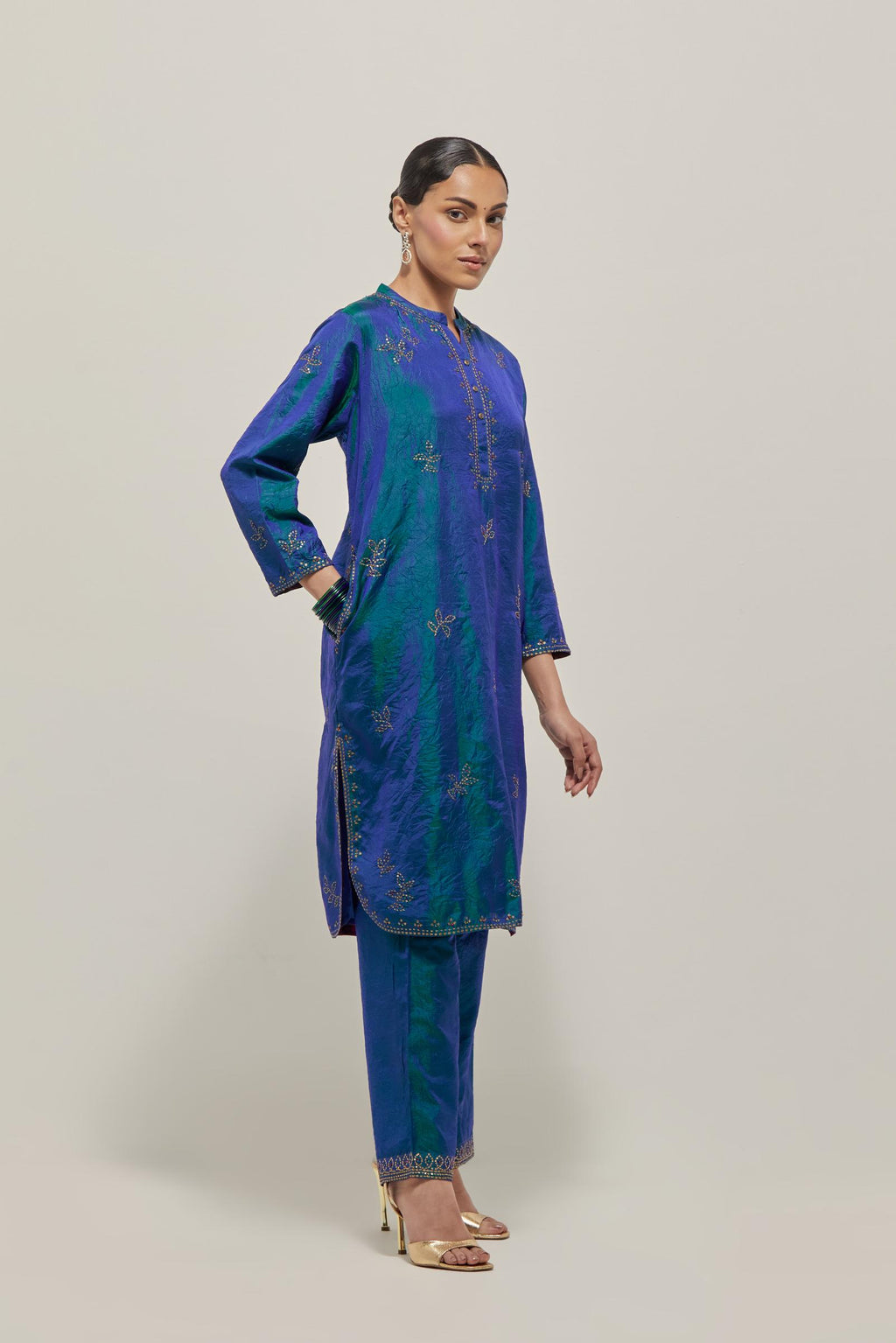 Teal Blue Silk short kurta set with hand embroidered sequins on bandhani inspired floral motifs all-over the kurta, highlighted with contrast-colored beads.