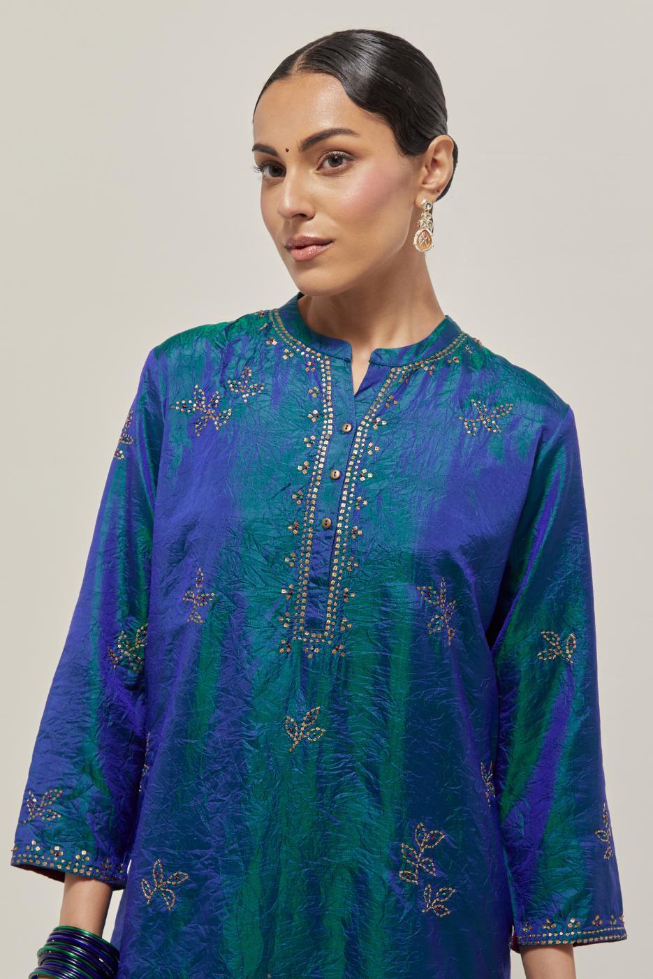 Teal Blue Silk short kurta set with hand embroidered sequins on bandhani inspired floral motifs all-over the kurta, highlighted with contrast-colored beads.