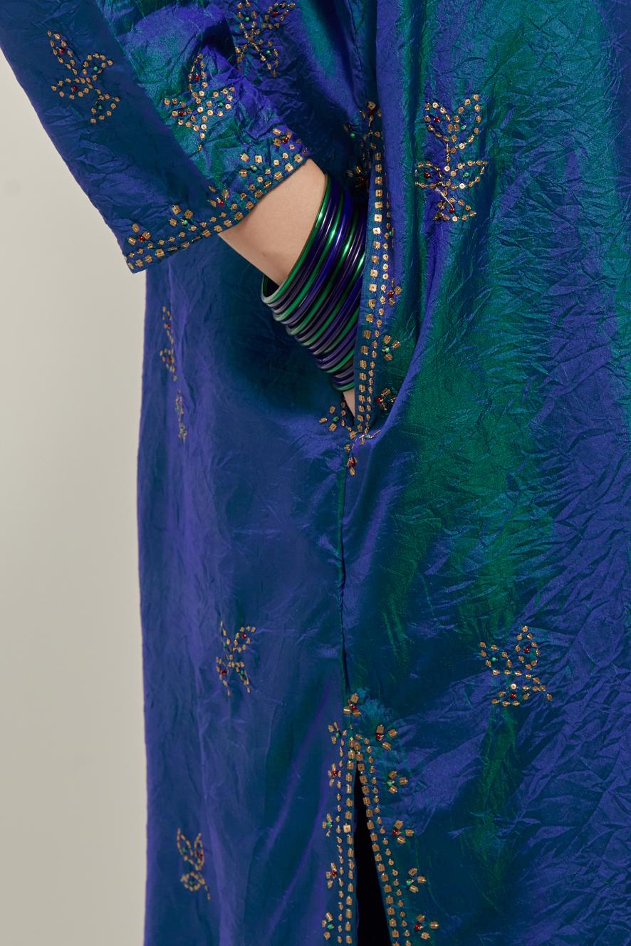 Teal Blue Silk short kurta set with hand embroidered sequins on bandhani inspired floral motifs all-over the kurta, highlighted with contrast-colored beads.