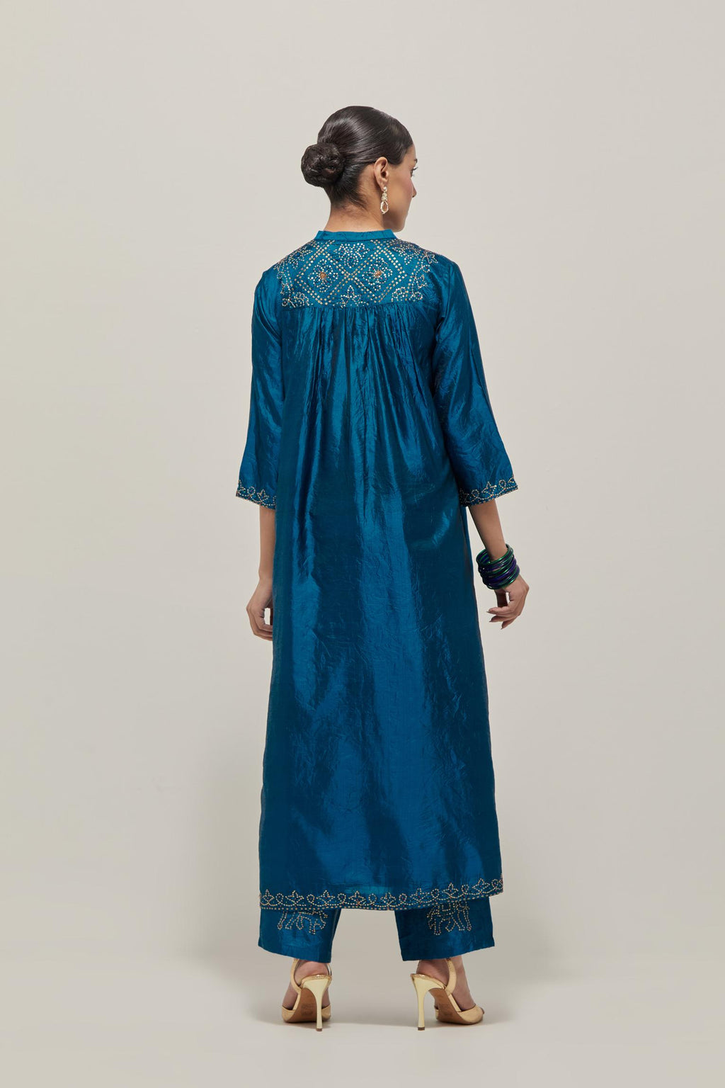 Teal Silk kurta dress set with hand embroidered sequins on bandhani inspired jaal work at neck, hem and sleeves cuff, highlighted with contrast-colored beads.