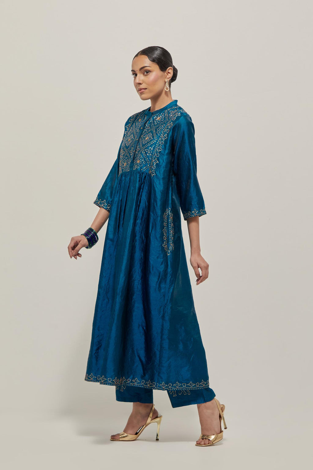 Teal Silk kurta dress set with hand embroidered sequins on bandhani inspired jaal work at neck, hem and sleeves cuff, highlighted with contrast-colored beads.