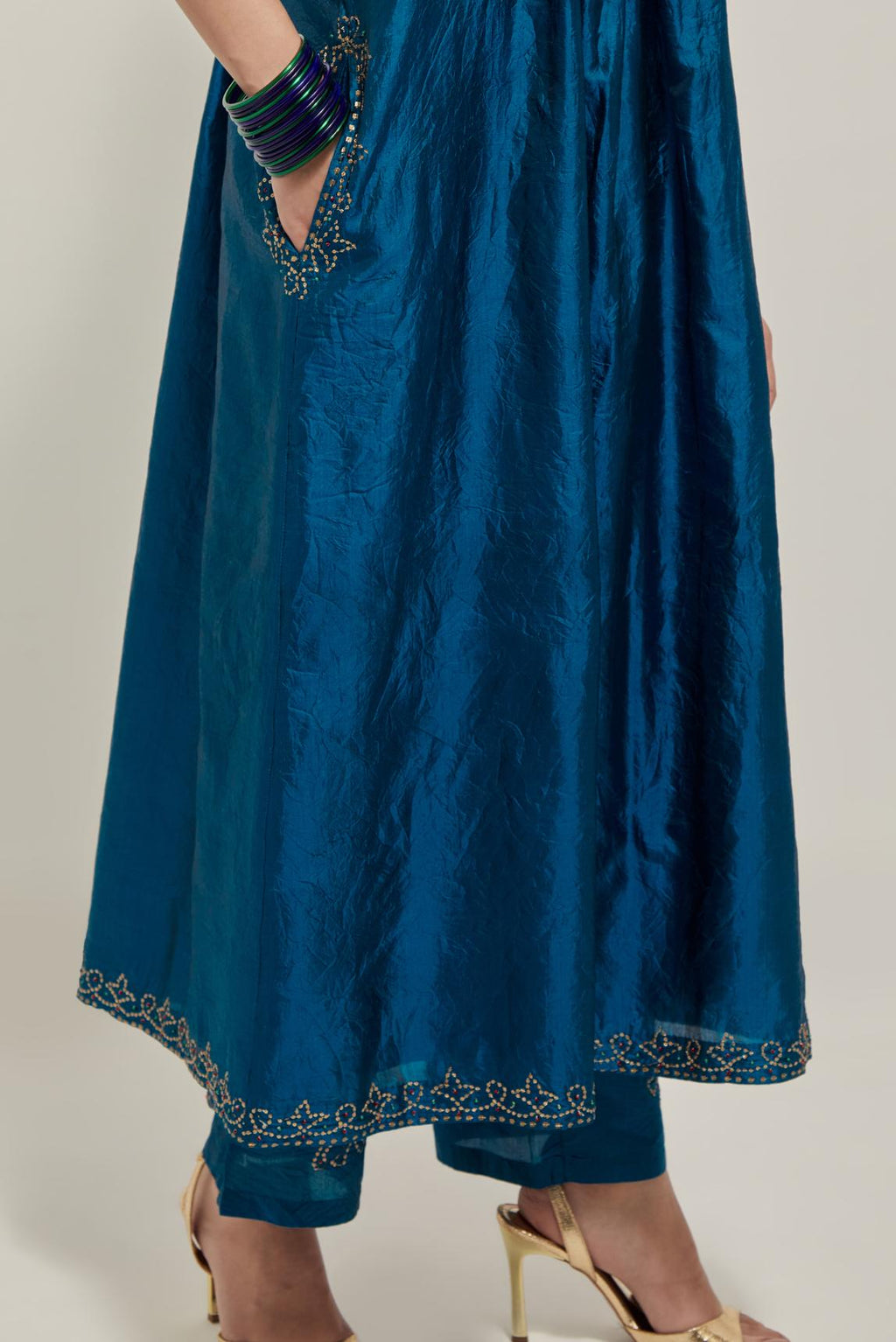 Teal Silk kurta dress set with hand embroidered sequins on bandhani inspired jaal work at neck, hem and sleeves cuff, highlighted with contrast-colored beads.