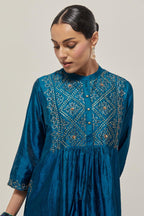Teal Silk kurta dress set with hand embroidered sequins on bandhani inspired jaal work at neck, hem and sleeves cuff, highlighted with contrast-colored beads.