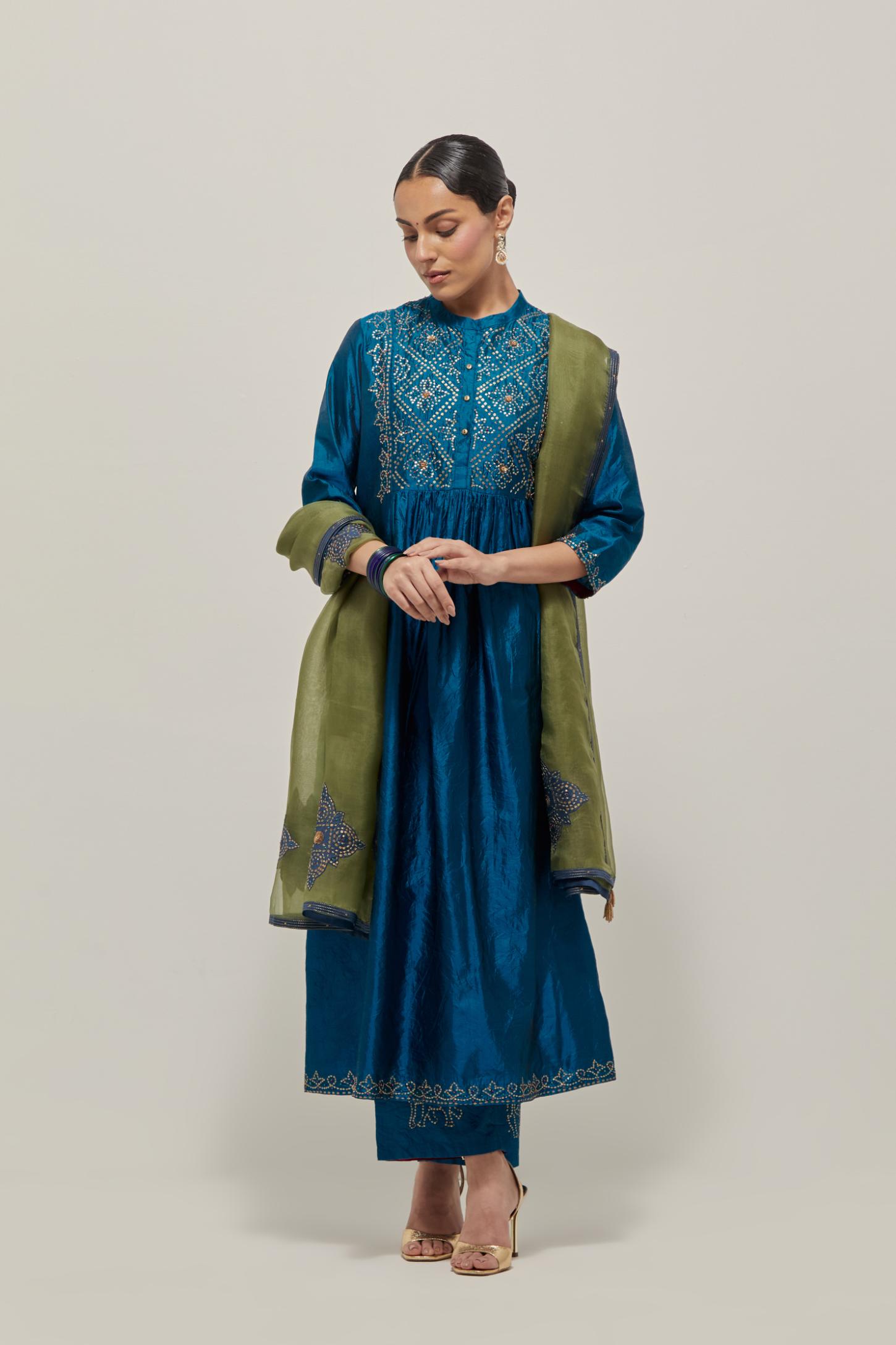 Teal Silk kurta dress set with hand embroidered sequins on bandhani inspired jaal work at neck, hem and sleeves cuff, highlighted with contrast-colored beads.