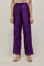 Purple silk pants with a narrow bandhani-inspired border at the hem, detailed with delicate bead and sequin work.