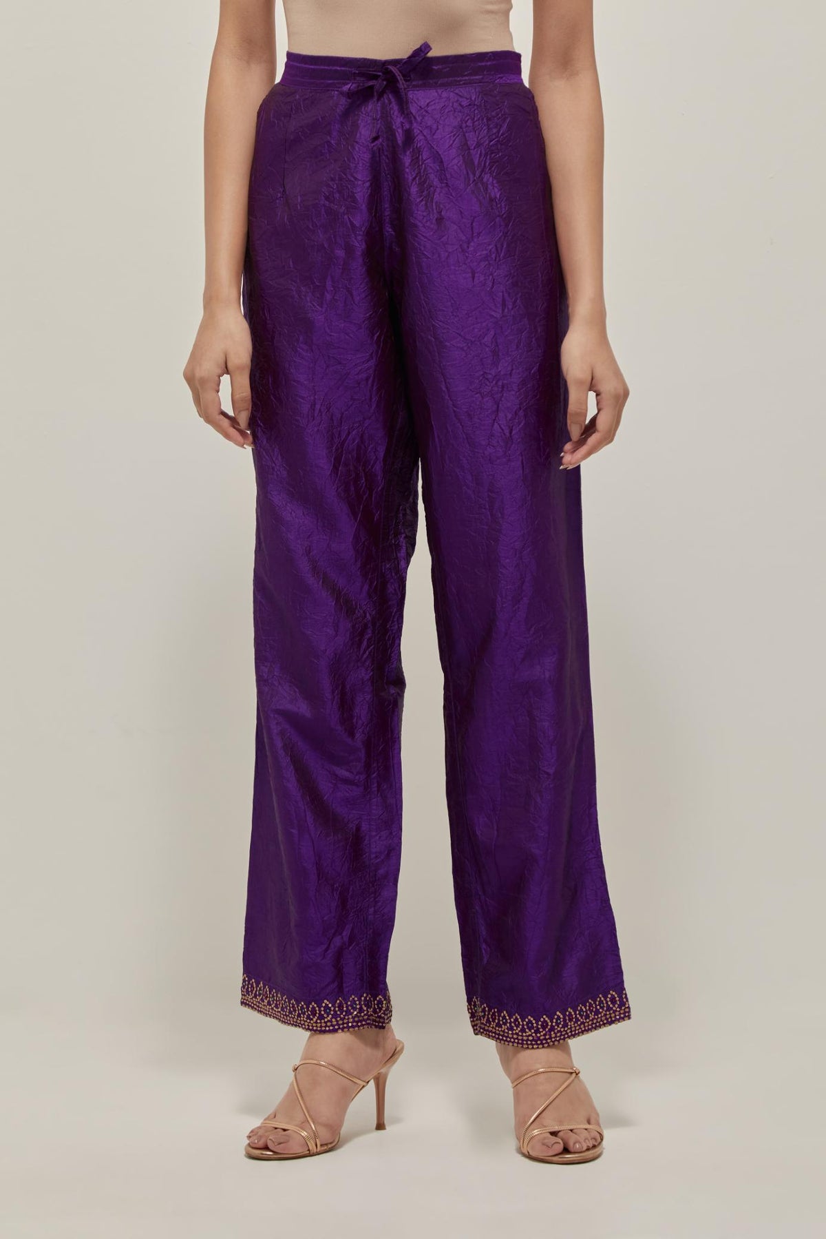 Purple silk pants with a narrow bandhani-inspired border at the hem, detailed with delicate bead and sequin work.