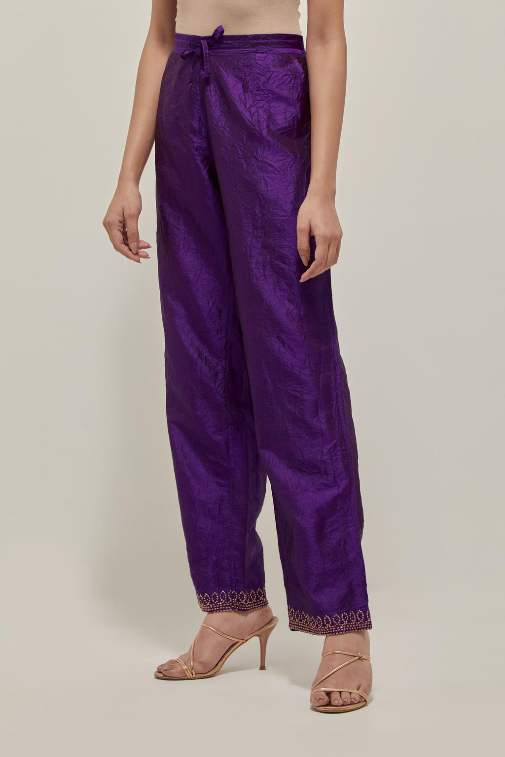 Purple silk pants with a narrow bandhani-inspired border at the hem, detailed with delicate bead and sequin work.