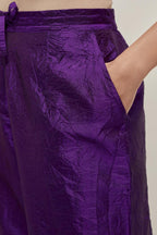 Purple silk pants with a narrow bandhani-inspired border at the hem, detailed with delicate bead and sequin work.