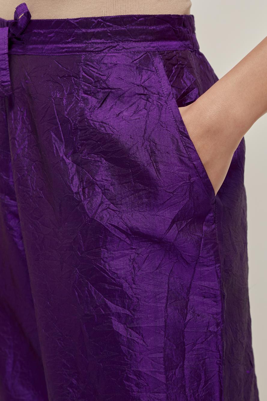 Purple silk pants with a narrow bandhani-inspired border at the hem, detailed with delicate bead and sequin work.