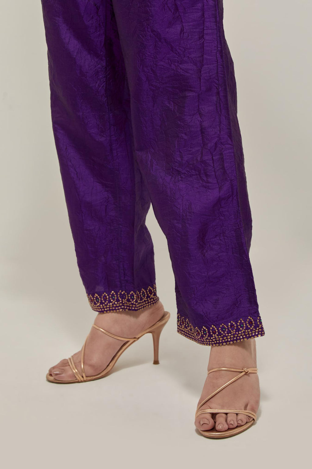Purple silk pants with a narrow bandhani-inspired border at the hem, detailed with delicate bead and sequin work.