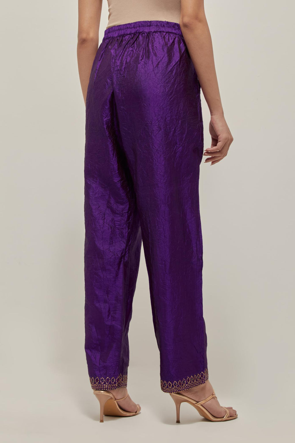 Purple silk pants with a narrow bandhani-inspired border at the hem, detailed with delicate bead and sequin work.