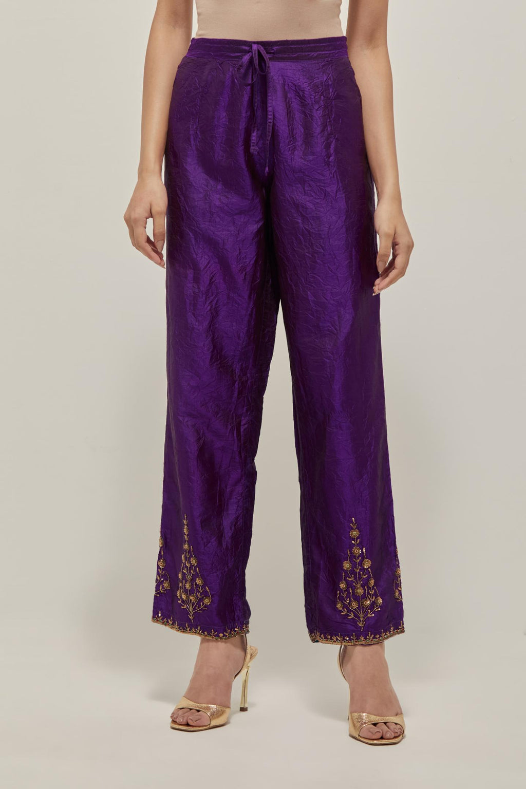 Purple Silk pants, highlighted with hand embroidered bead, sequins and zardozi boota at hem, highlighted with contrast bead work.