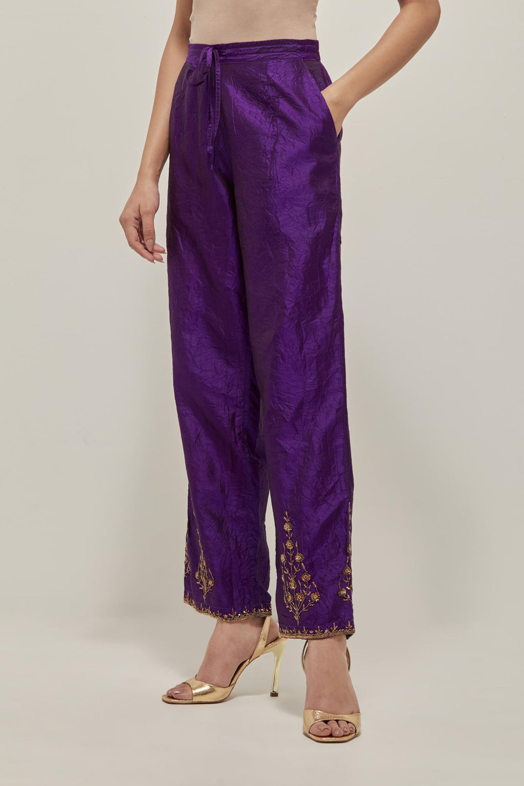 Purple Silk pants, highlighted with hand embroidered bead, sequins and zardozi boota at hem, highlighted with contrast bead work.
