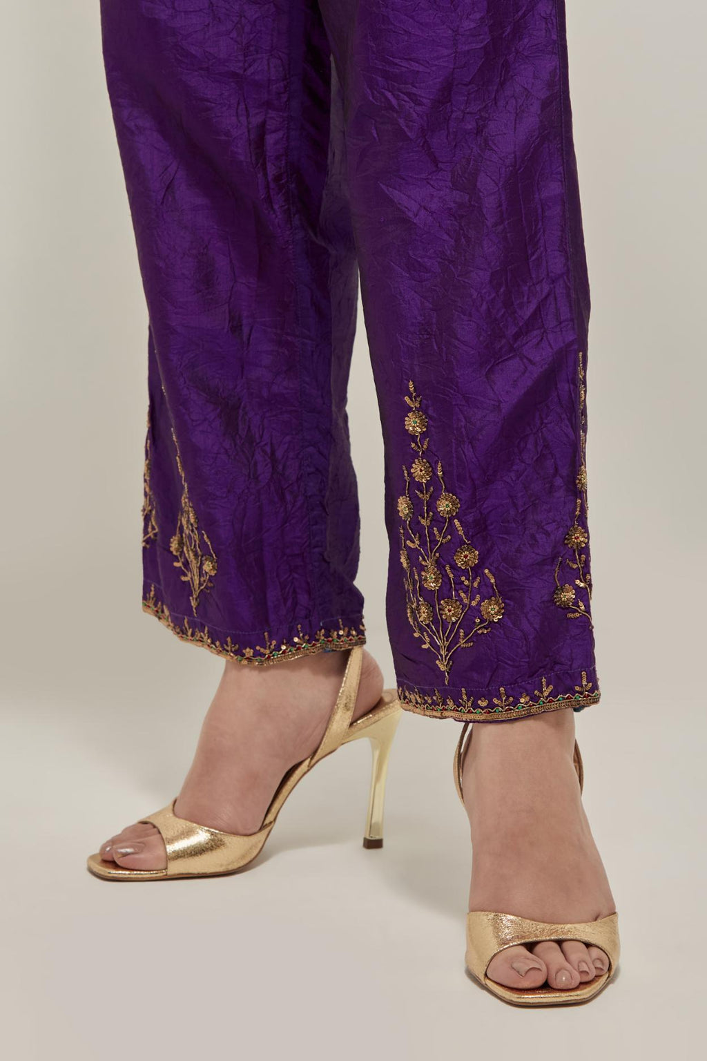 Purple Silk pants, highlighted with hand embroidered bead, sequins and zardozi boota at hem, highlighted with contrast bead work.