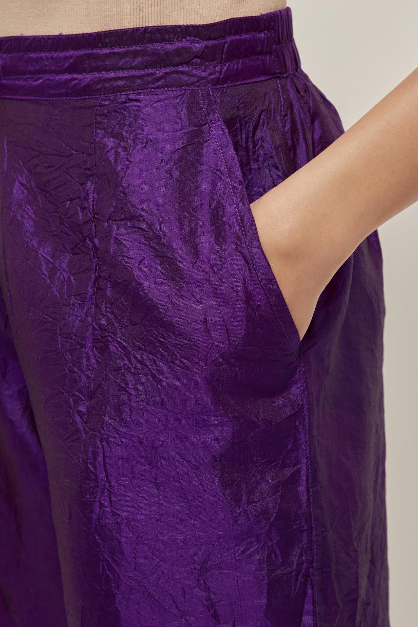 Purple Silk pants, highlighted with hand embroidered bead, sequins and zardozi boota at hem, highlighted with contrast bead work.