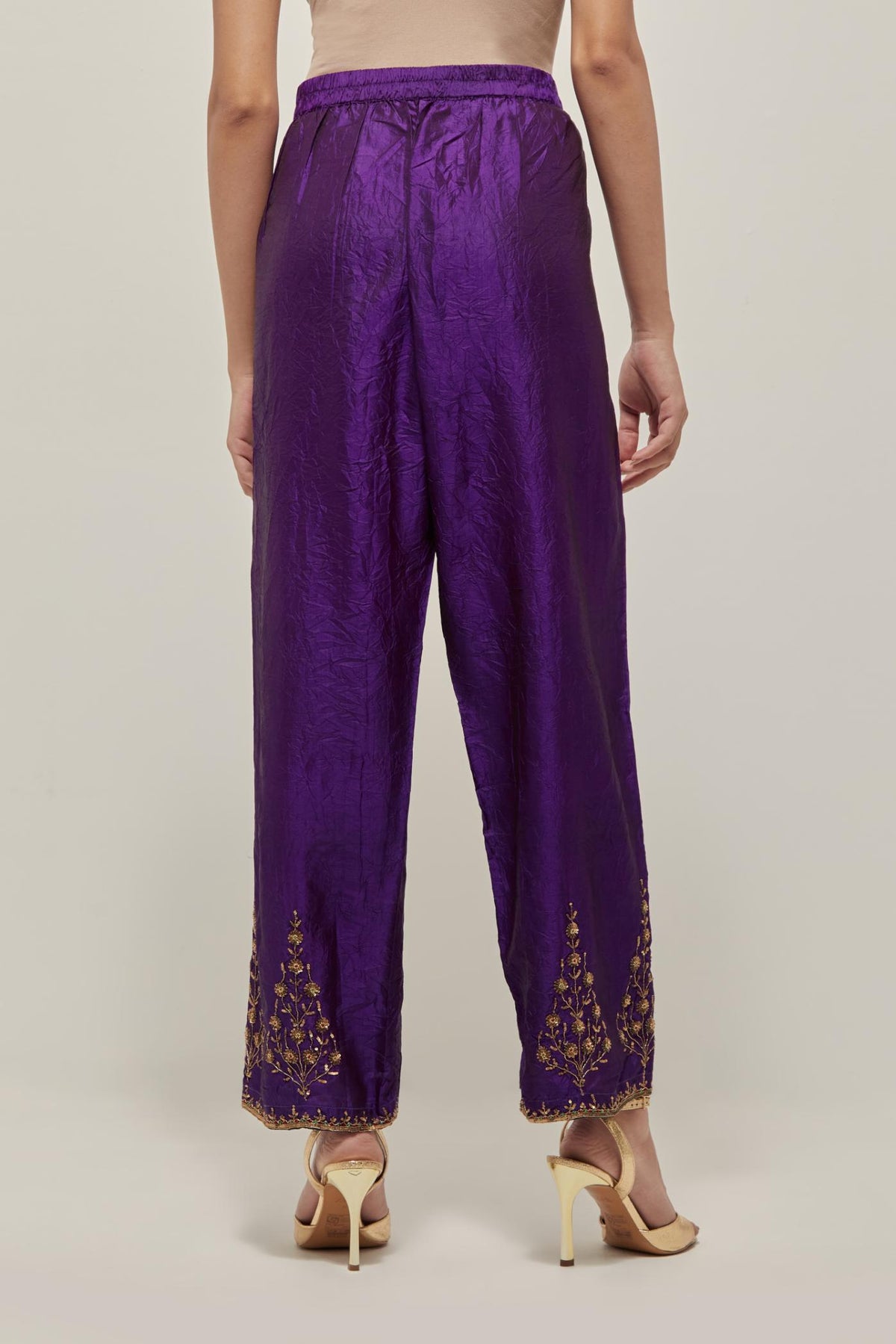 Purple Silk pants, highlighted with hand embroidered bead, sequins and zardozi boota at hem, highlighted with contrast bead work.