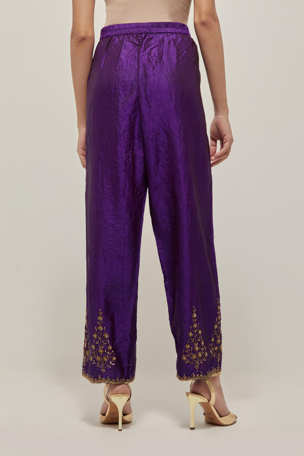 Purple Silk pants, highlighted with hand embroidered bead, sequins and zardozi boota at hem, highlighted with contrast bead work.