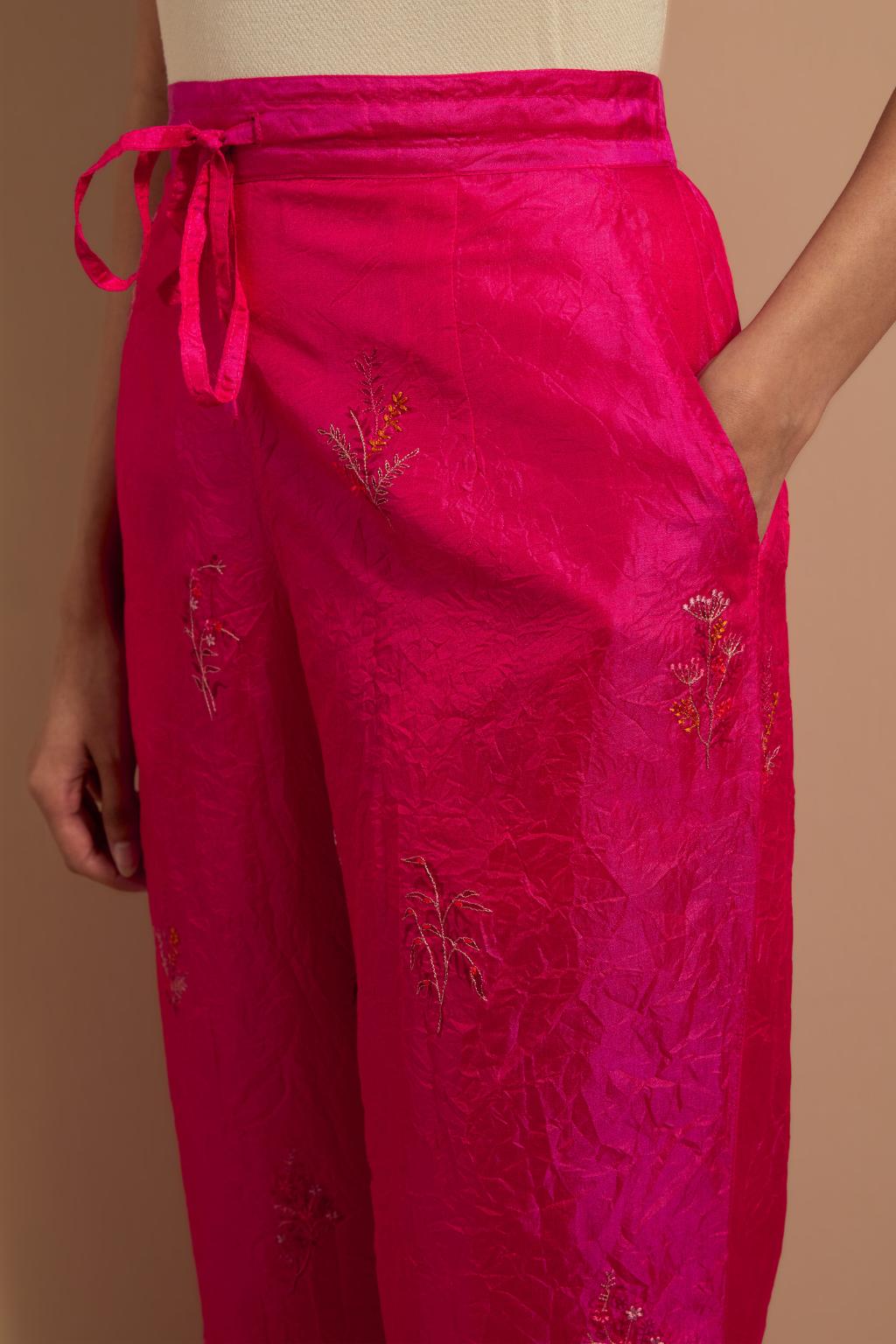 Fuchsia crushed silk hand block printed pants, highlighted with multi colored thread embroidery.