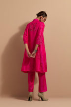 Fuchsia crushed silk A-line short kurta set with hand block print, highlighted with multi colored thread embroidery.