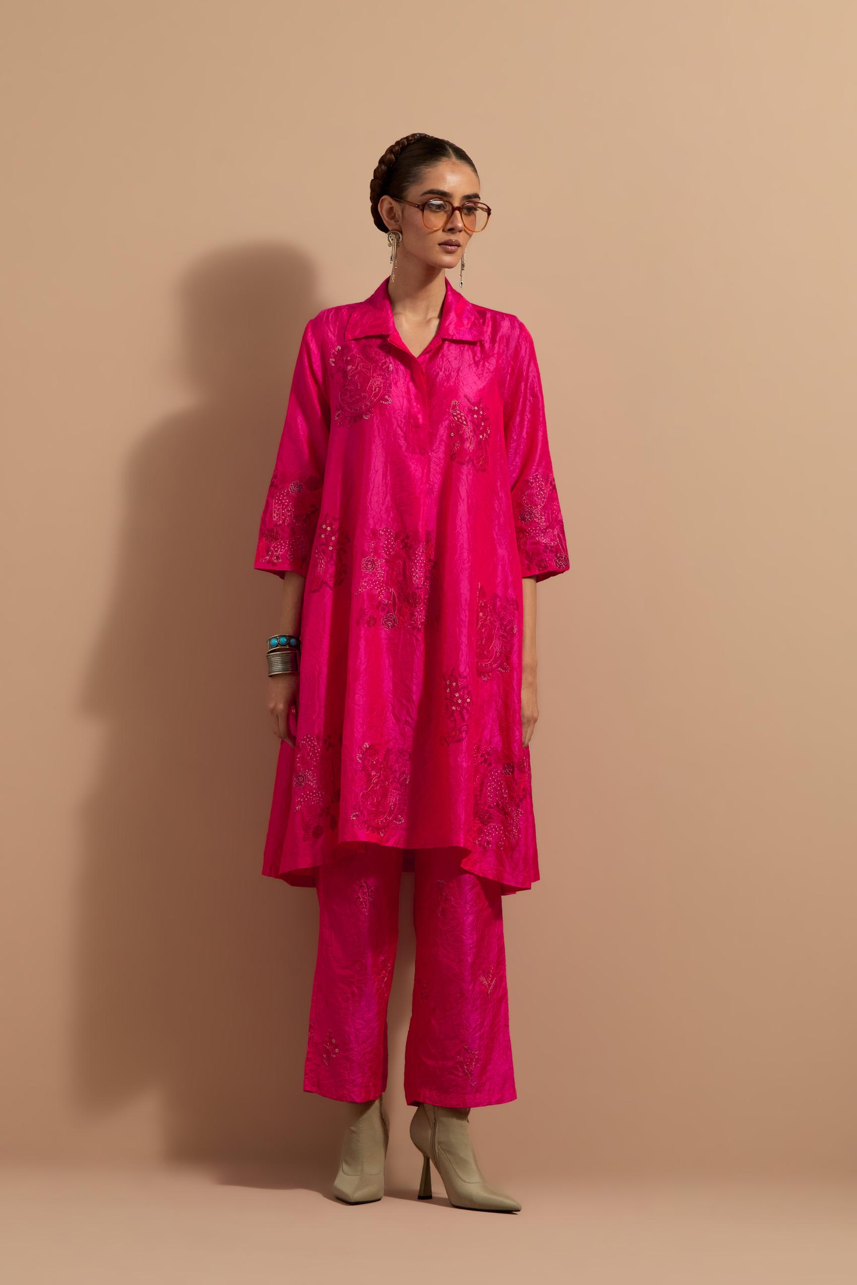 Fuchsia crushed silk A-line short kurta set with hand block print, highlighted with multi colored thread embroidery.