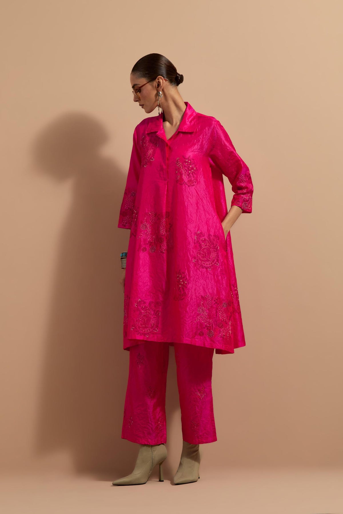 Fuchsia crushed silk A-line short kurta set with hand block print, highlighted with multi colored thread embroidery.