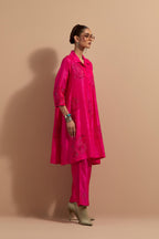 Fuchsia crushed silk A-line short kurta set with hand block print, highlighted with multi colored thread embroidery.
