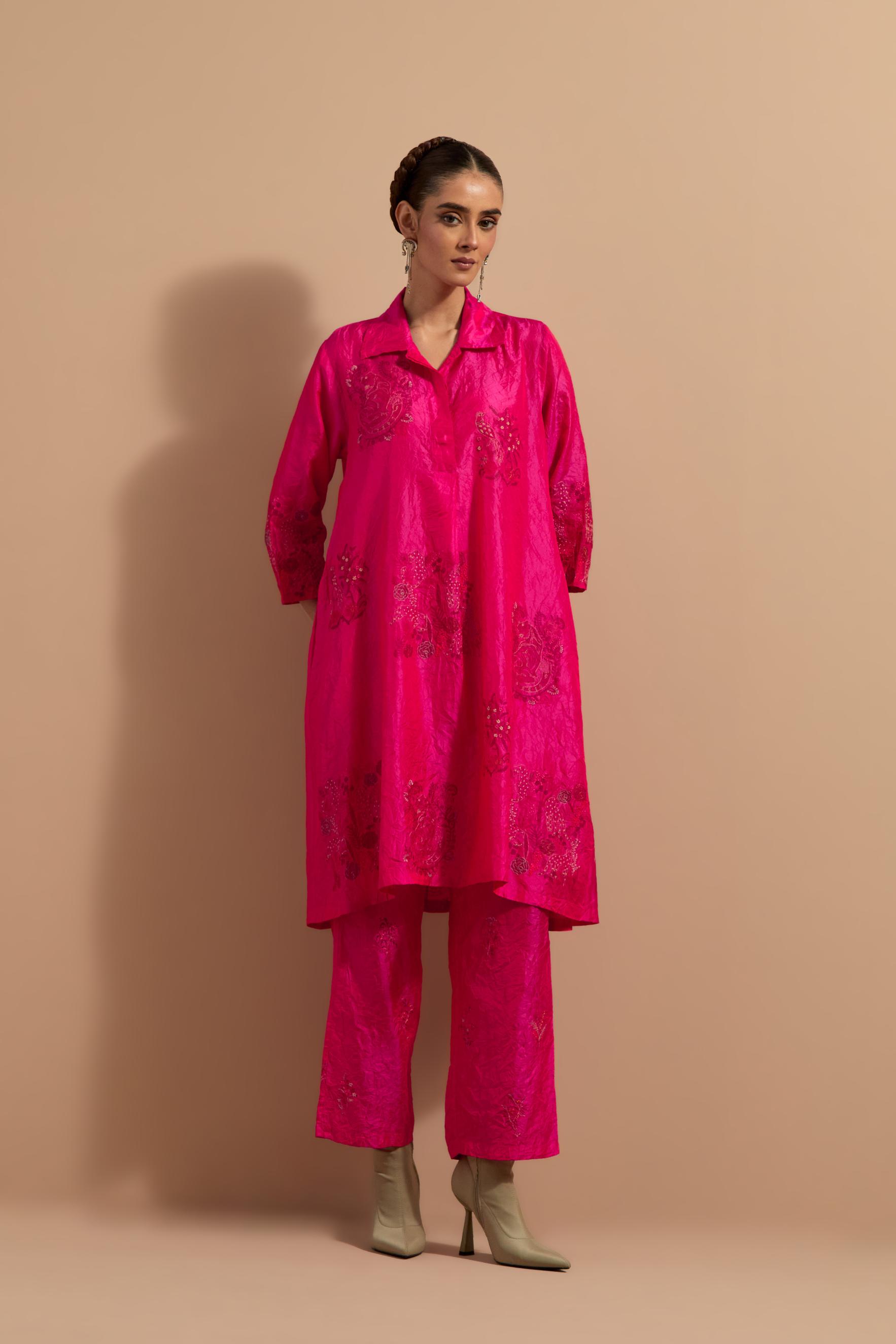 Fuchsia crushed silk A-line short kurta set with hand block print, highlighted with multi colored thread embroidery.