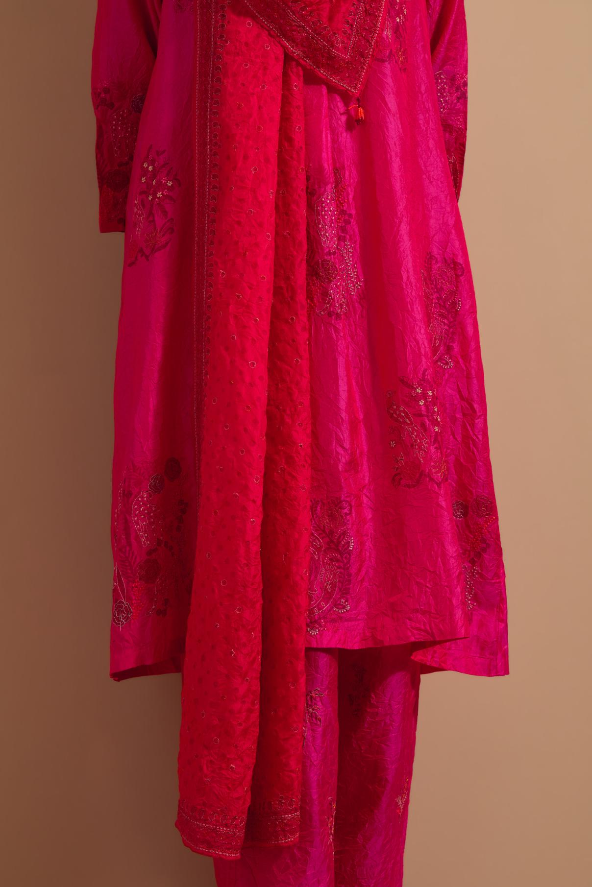 Fuchsia crushed silk A-line short kurta set with hand block print, highlighted with multi colored thread embroidery.